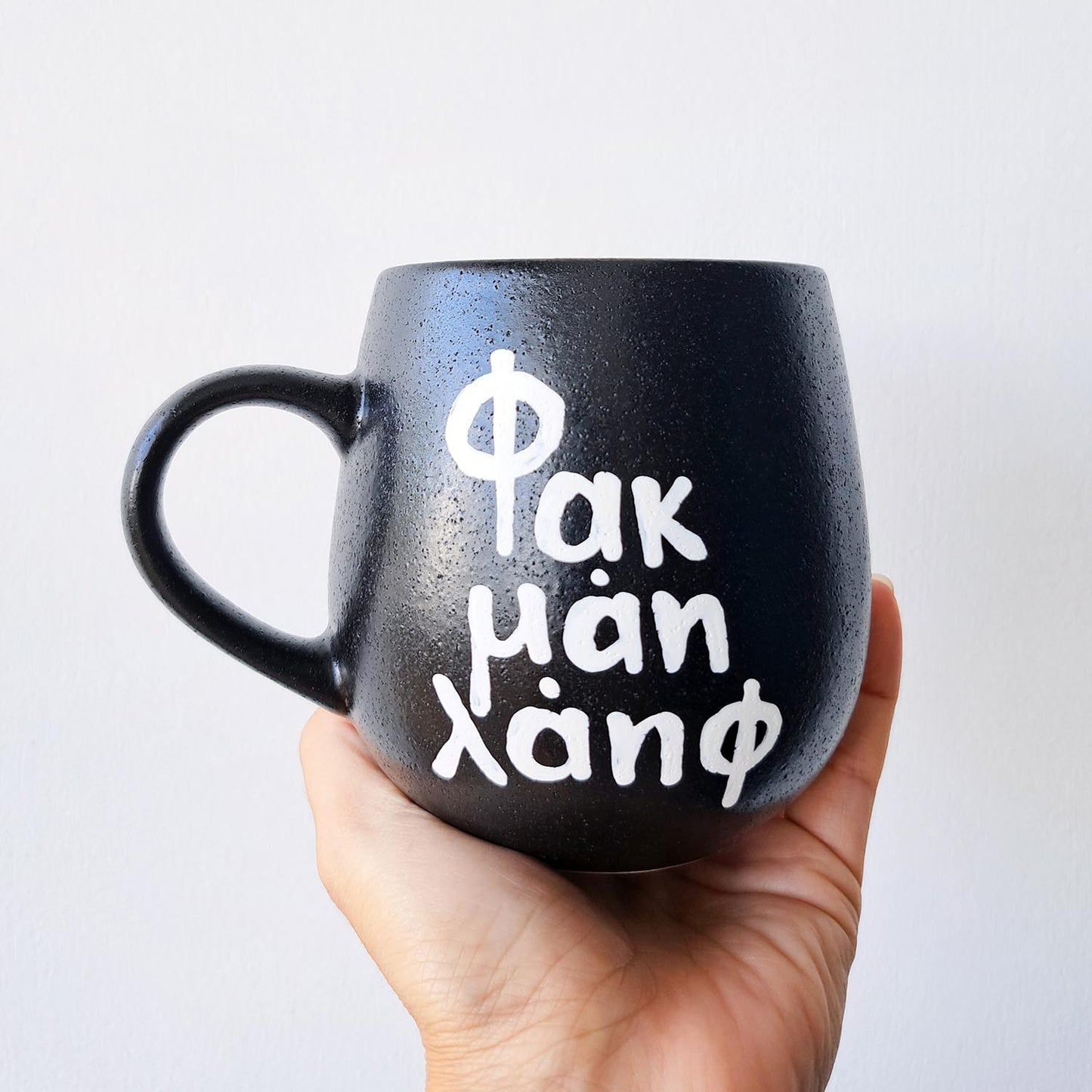 Hand painted black ceramic mug, "Φακ μαη λάηφ"