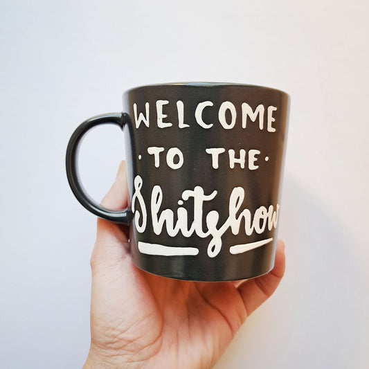 Hand painted black ceramic mug, "Welcome to the shitshow"