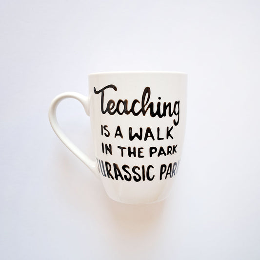 Hand painted black ceramic mug, "Teaching is a walk in the park"